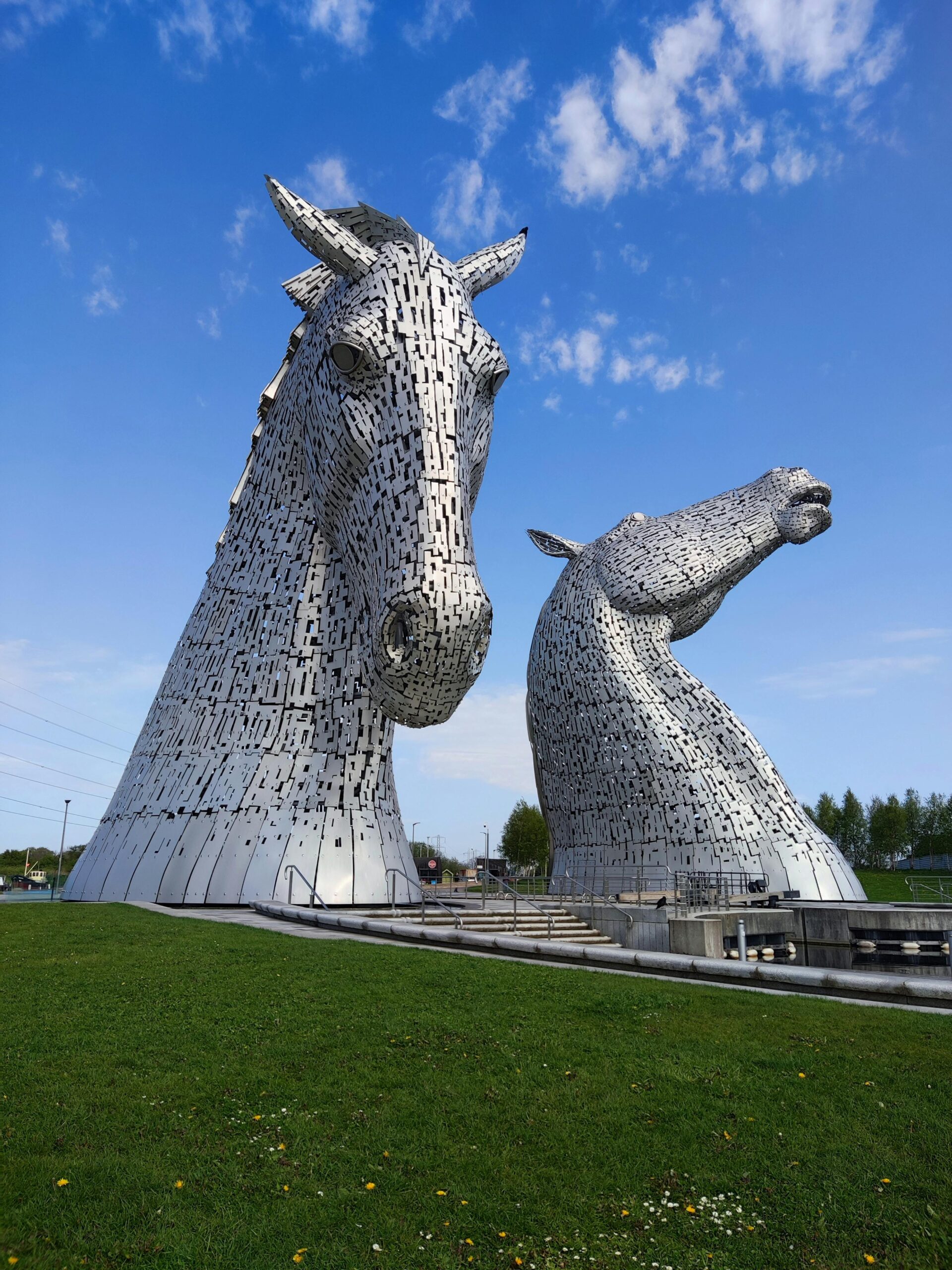 Stunning view of The Kelpies sculptures under a bright blue sky in summer.