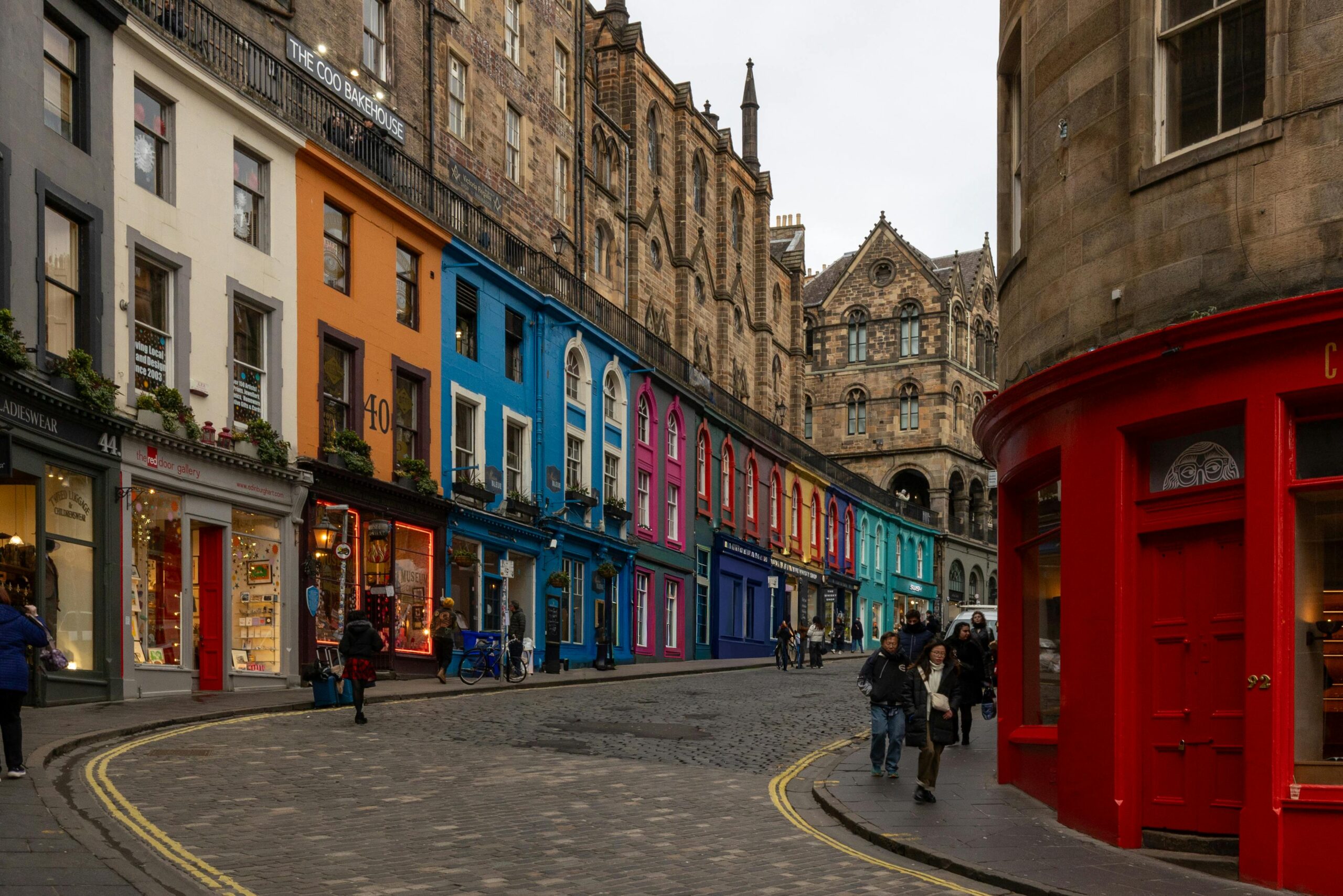 Charming Edinburgh street with colorful shops and historic architecture, perfect for exploration. Victoria Street Edinburgh. Cruise day tour, cruise excursion, shore excursion Edinburgh, tours from Edinburgh ports